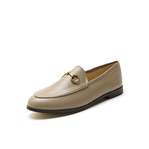 Women with horseshoe buckles and loafers wearing flat bottomed small leather shoes