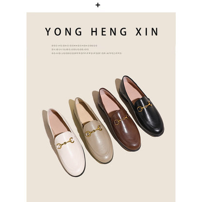 Women with horseshoe buckles and loafers wearing flat bottomed small leather shoes